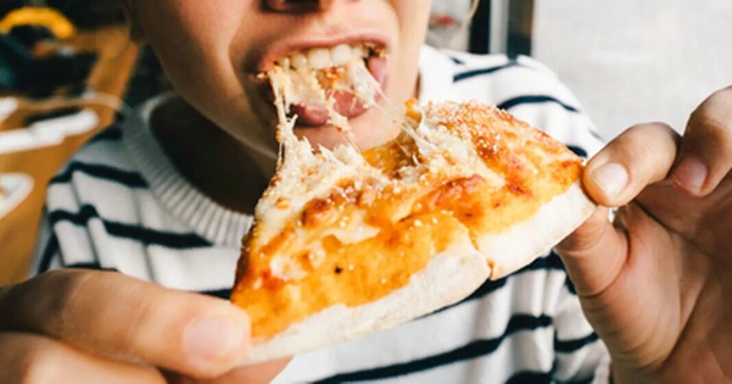 1_young-woman-is-eating-cheese-pizza-with-pleasure