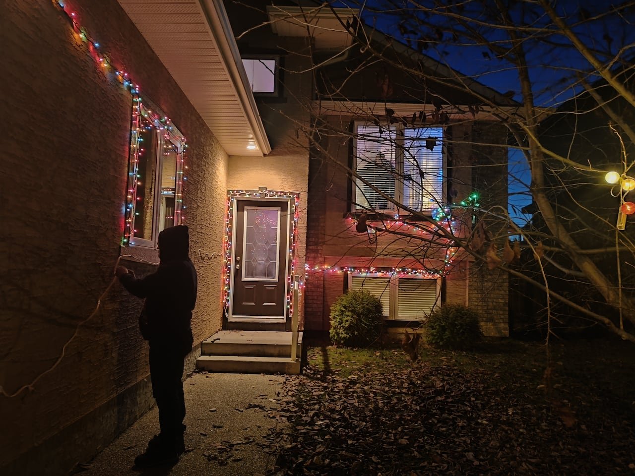 default-175 A house adorned with Christmas lights at night.